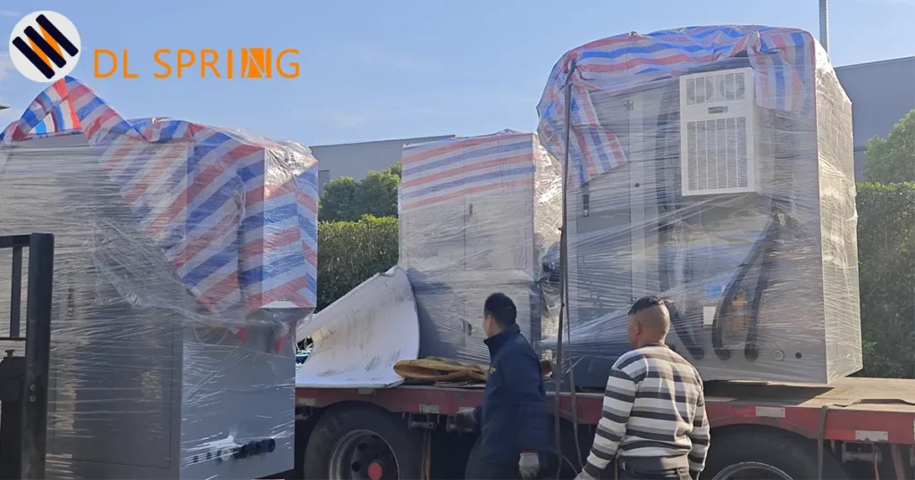 New spring coiling machine wrapped in protective packaging on delivery truck at Dingli Spring factory