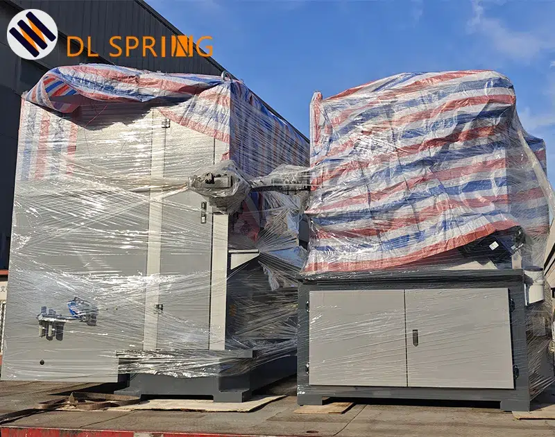 New spring coiling machine wrapped in protective packaging on delivery truck at Dingli Spring factory