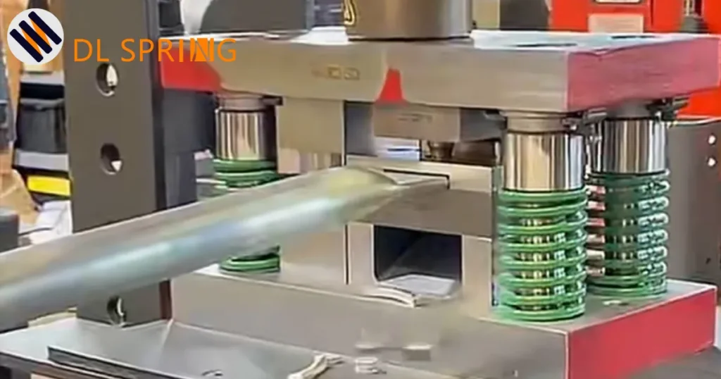 ISO 10243 die springs installed in stamping machine showing green compression springs in metal forming operation