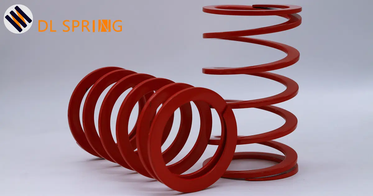 Large pitch rectangular wire compression spring with red electrophoretic coating manufactured by DL Spring showing extended coil spacing