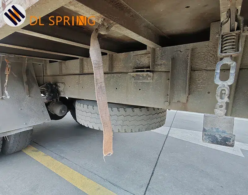 Box truck chassis view showing multiple side panel latch assemblies in real outdoor service