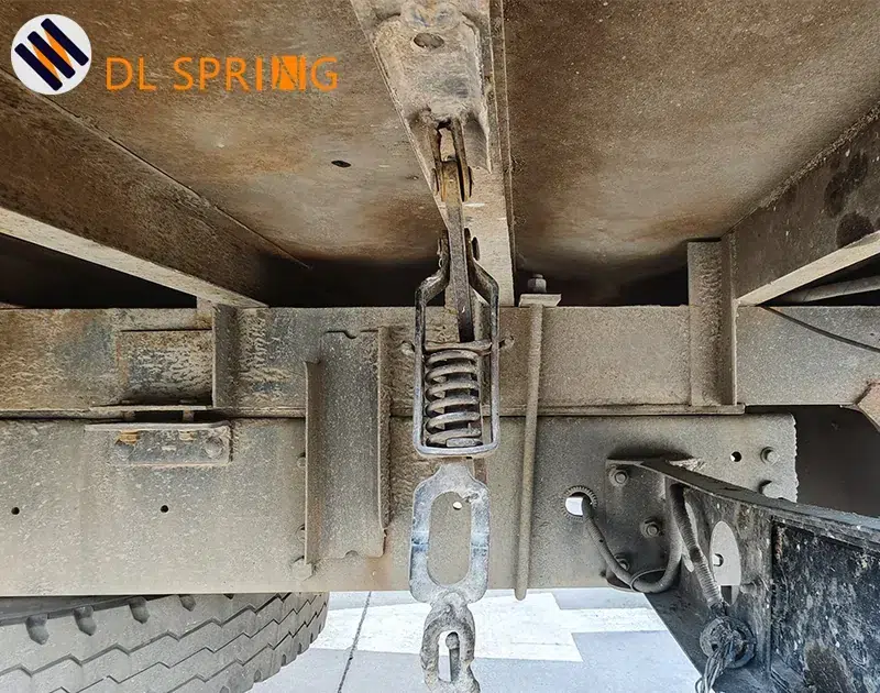 Close-up of a heavy-duty close-coiled compression spring inside a box truck side panel latch assembly