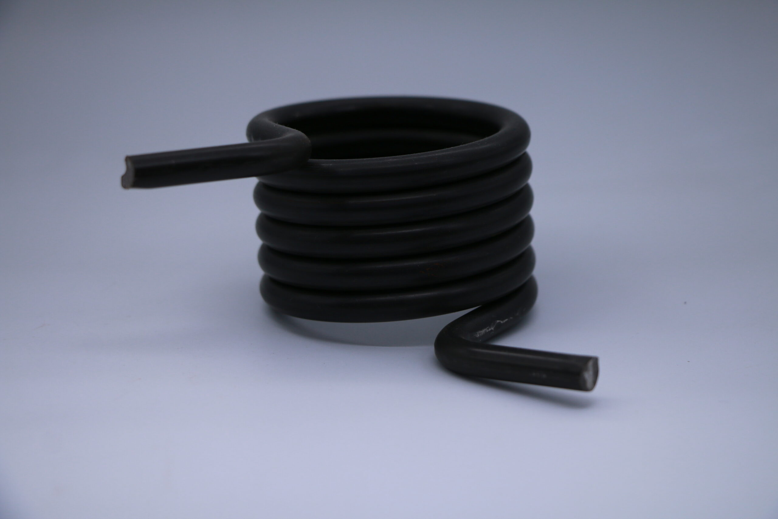 Bent torsion spring legs and their connections to the coil body